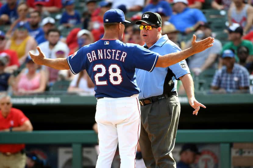 Texas Rangers manager Jeff Banister (28) argues with third base umpire Sam Holbrook after...