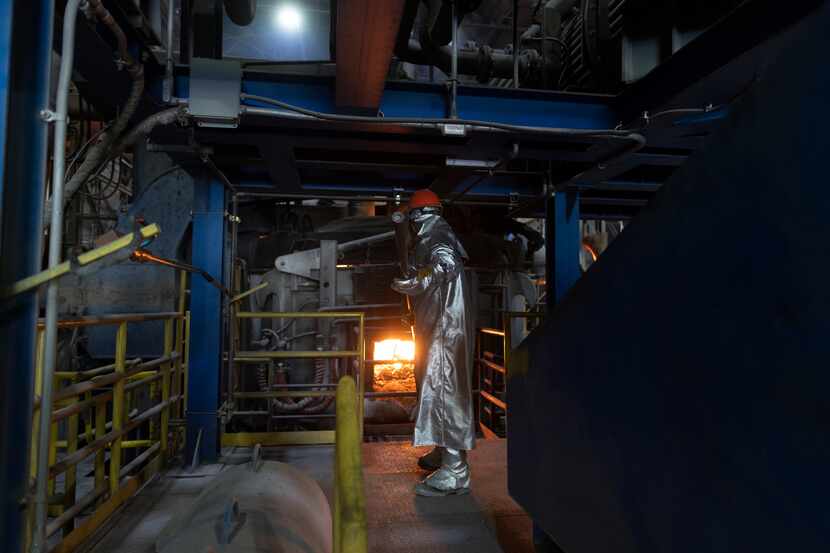 An employee takes a temperature sample at ATI's state-of-the-art electric arc furnace in...