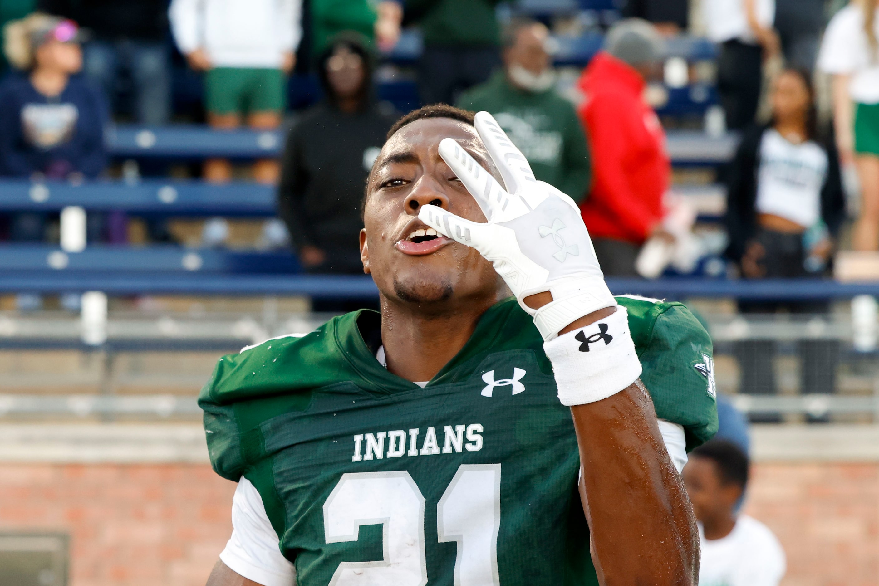 Waxahachie high’s D’Marion Cooper (21) celebrates following their win against North Forney...