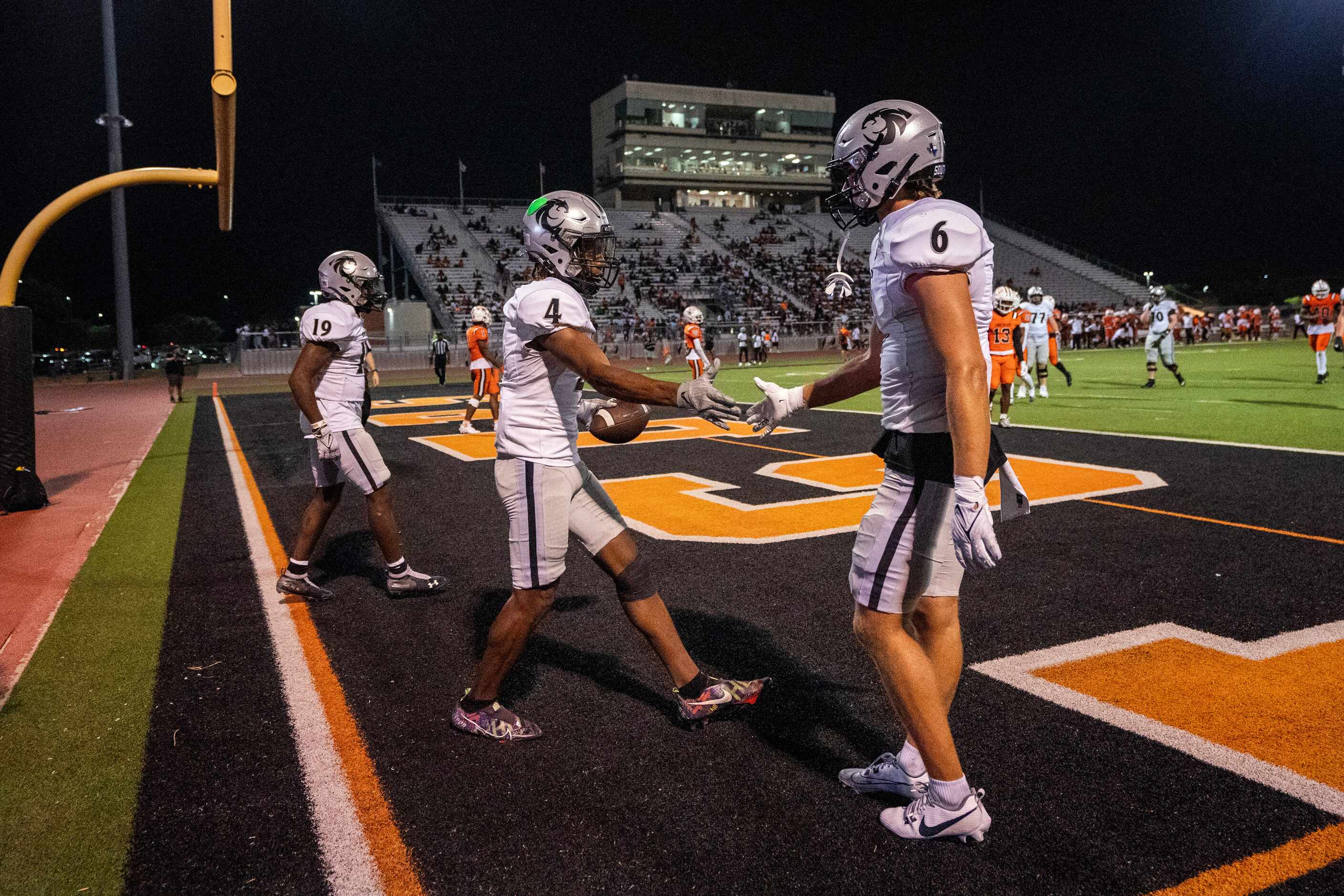 Denton Guyer senior wide receiver Josiah Martin 4) is congratulated by senior wide receiver...