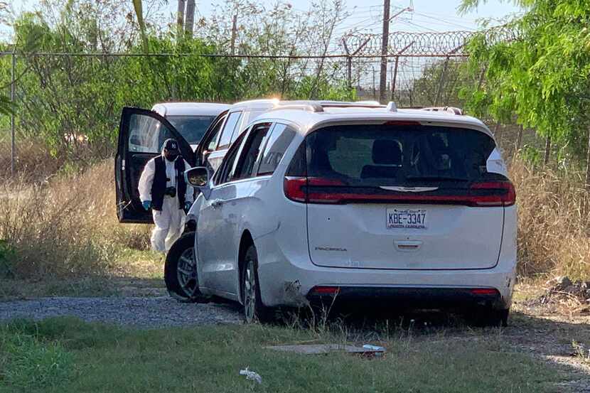 A Mexican police investigator inspects the minivan where four Americans where shot and taken...