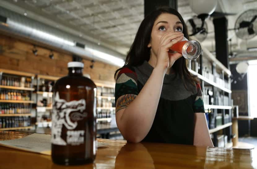 Lindsay Swinson tastes a glass of beer at Craft & Growler, photographed September 26, 2014.