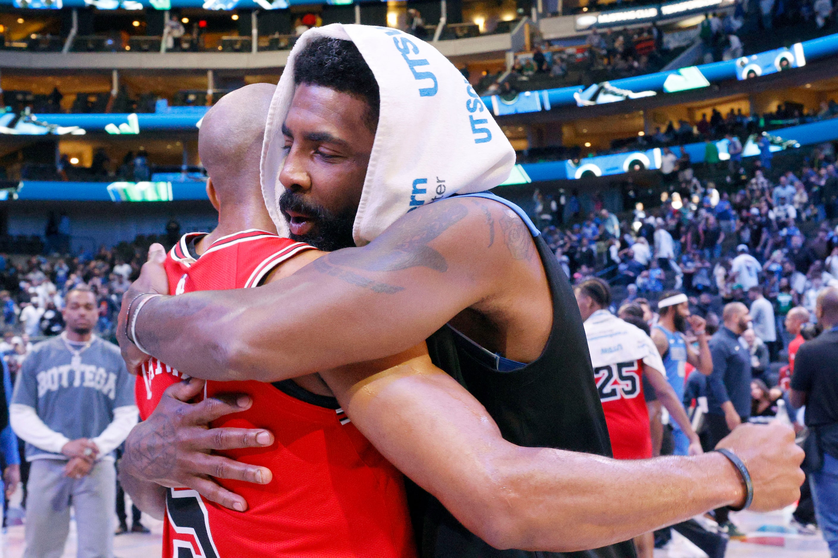 Dallas Mavericks guard Kyrie Irving (11), right, receives a hug from Chicago Bulls guard...