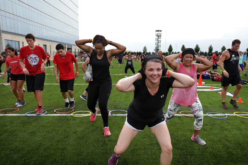 Community members take part in a CrossFit challenge during a Camp Gladiator stadium takeover...