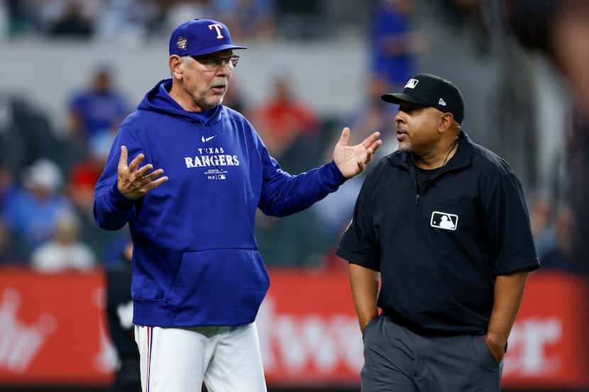 Texas Rangers manager Bruce Bochy argues with umpire Adrian Johnson after a dropped popup in...