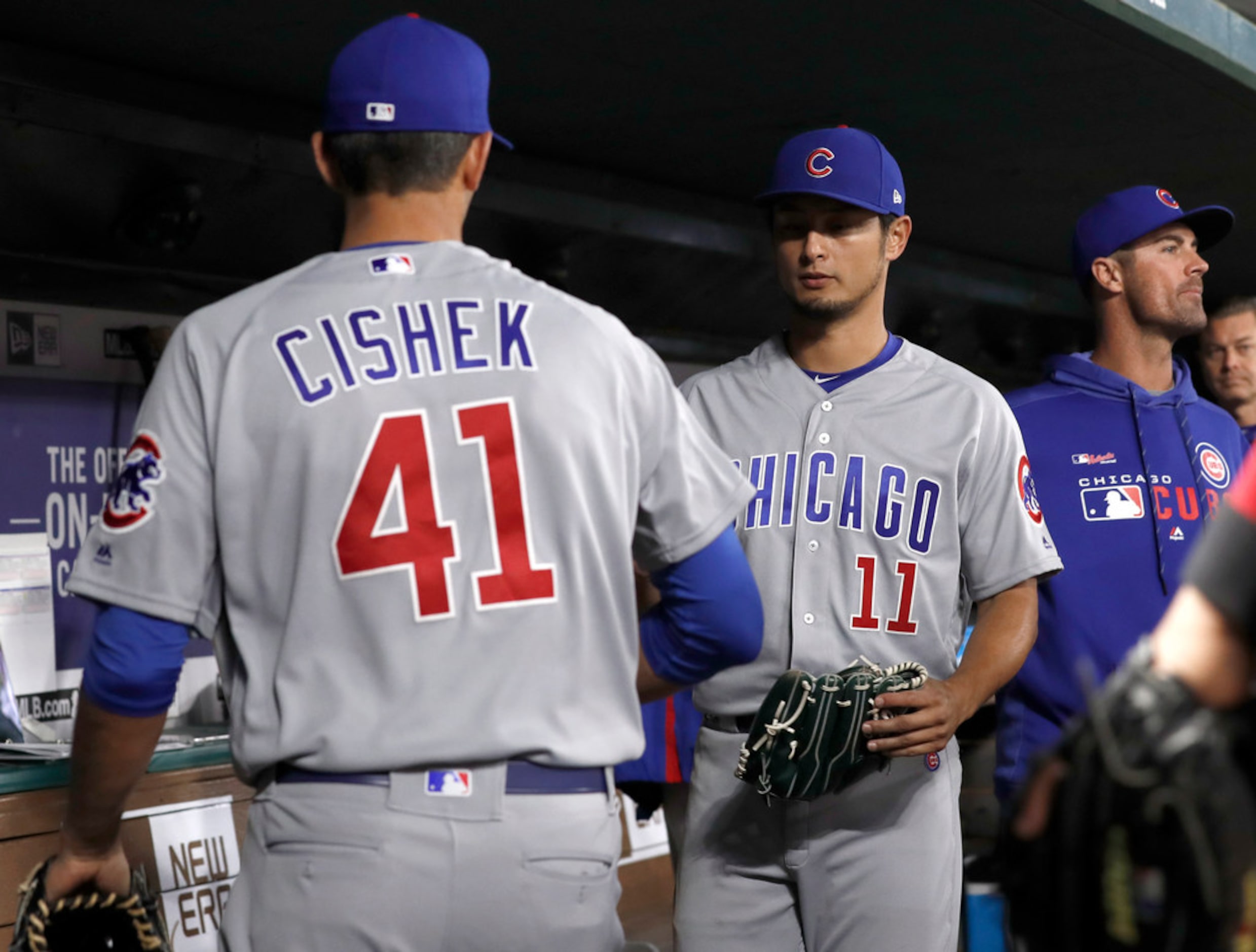 Chicago Cubs relief pitcher Steve Cishek (41) is greeted in the dugout by starting pitcher...