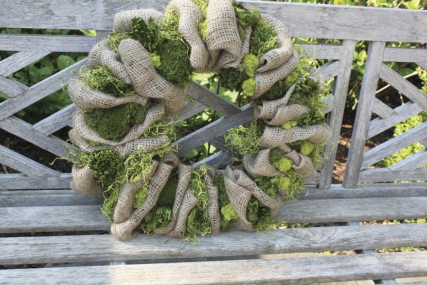 A classic, lush, American boxwood wreath anchored by a rustic burlap ribbon is $144 at...