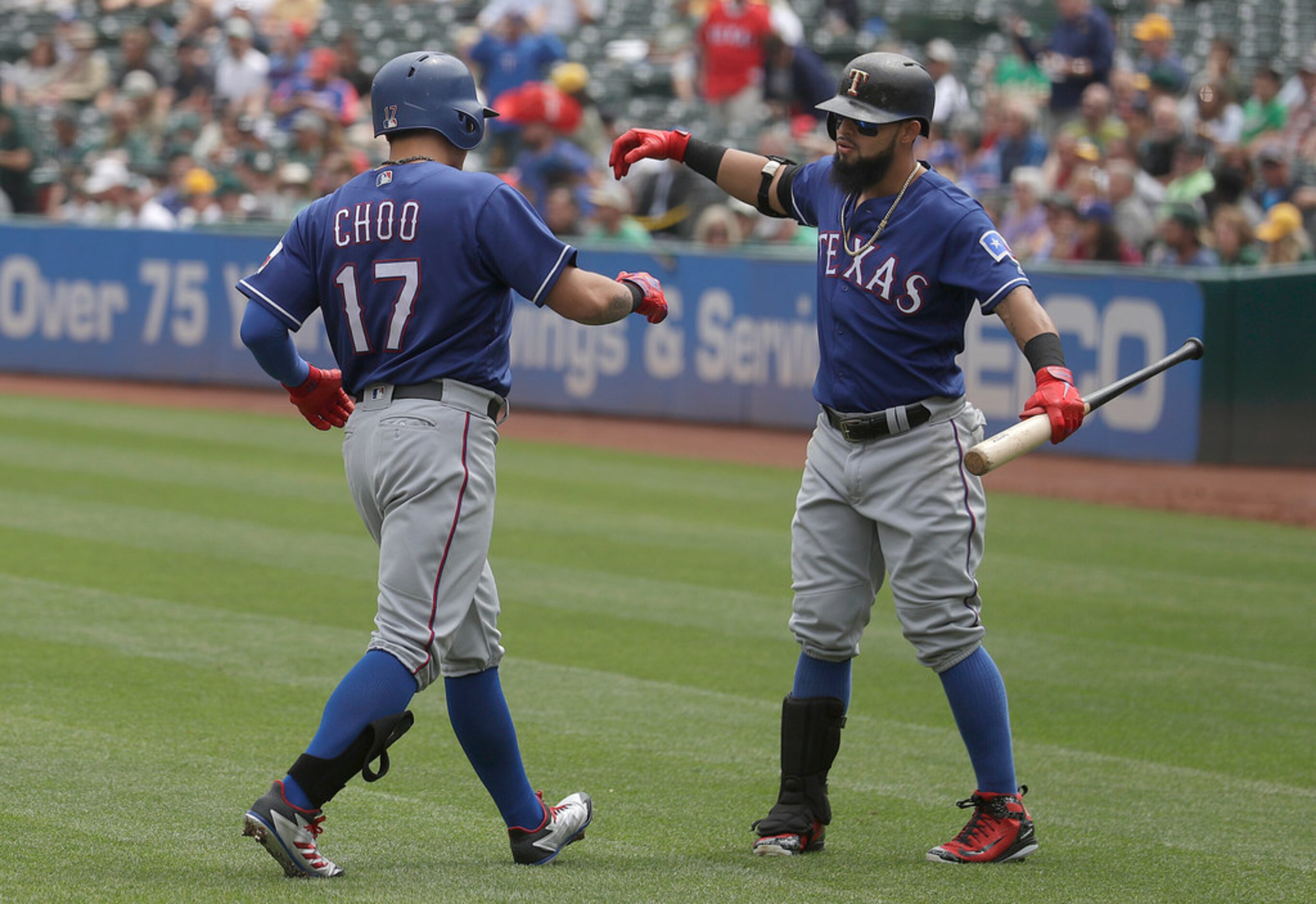 Texas Rangers' Shin-Soo Choo (17) is congratulated by Rougned Odor after hitting a solo home...