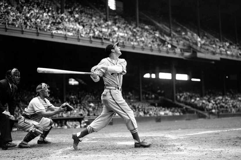 In this file photo, St. Louis Cardinals' Stan Musial bats against the Philadelphia Phillies...