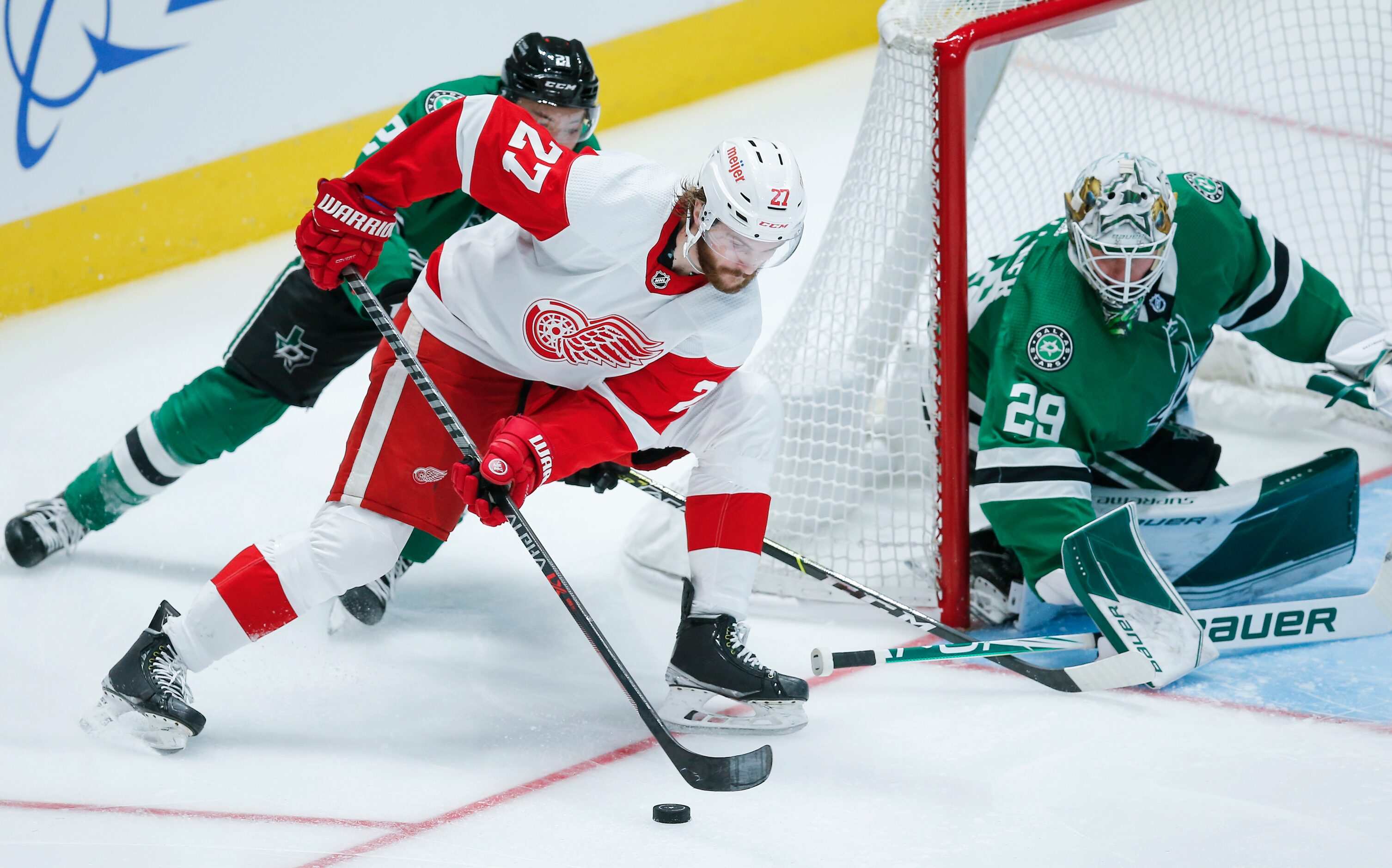 Detroit Red Wings forward Michael Rasmussen (27) attempts a shot as Dallas Stars goaltender...