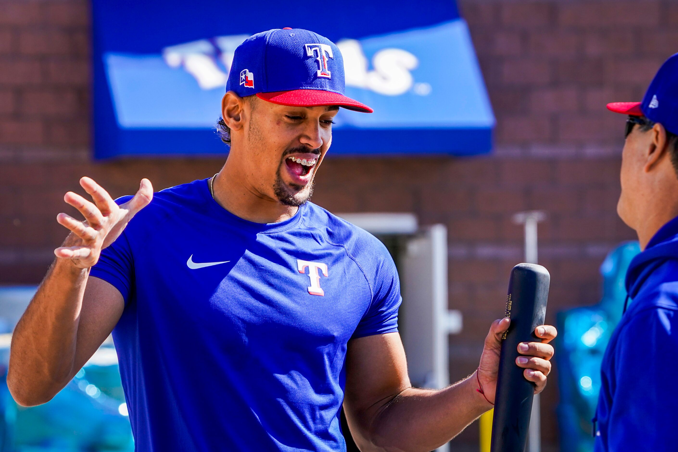 Texas Rangers first baseman Ronald Guzman greets bench coach Don Wakamatsu during a training...