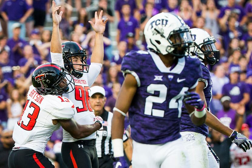 Texas Tech place kicker Clayton Hatfield (96) celebrates with holder Cameron Batson (13)...