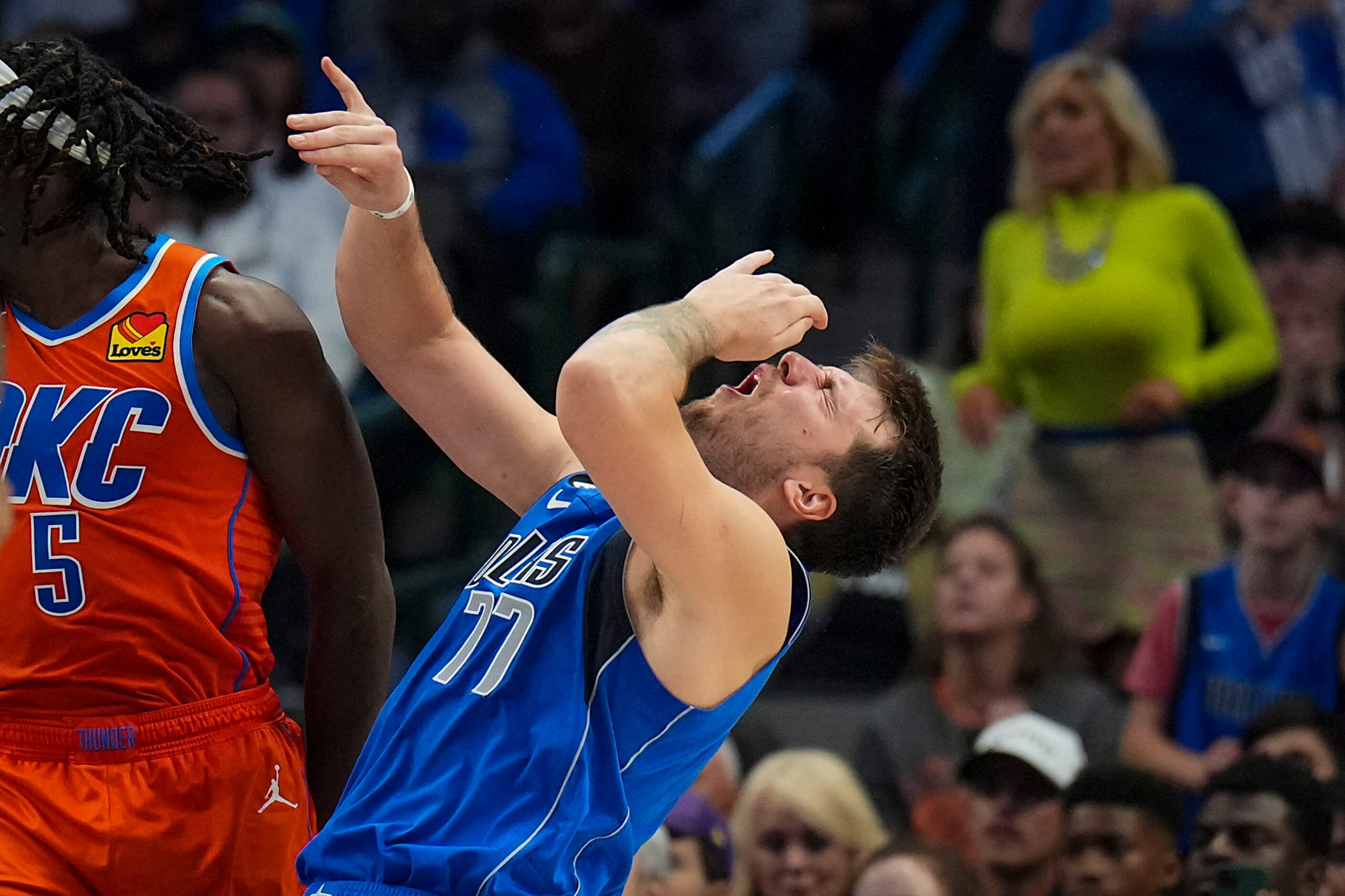 Dallas Mavericks guard Luka Doncic (77) reacts after being hit in the face on a drive...