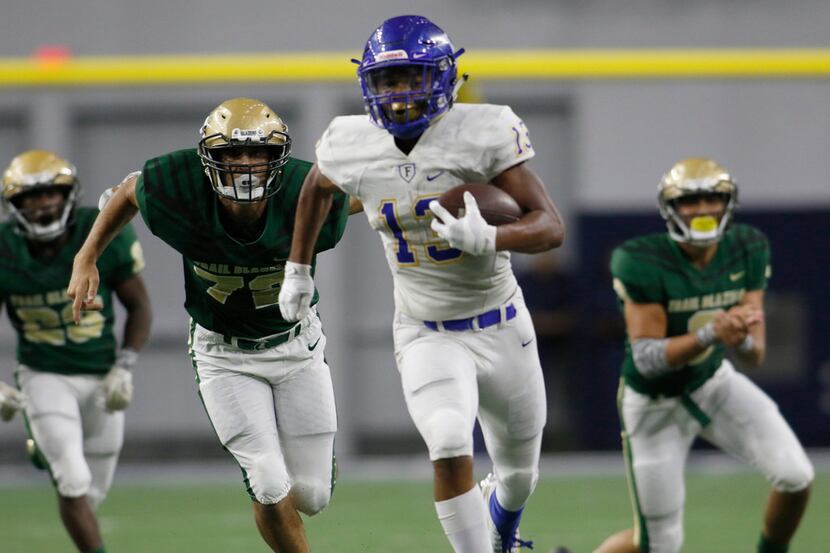 Frisco running back Blake May (13) sprints past members of the Frisco Lebanon Trail defense...