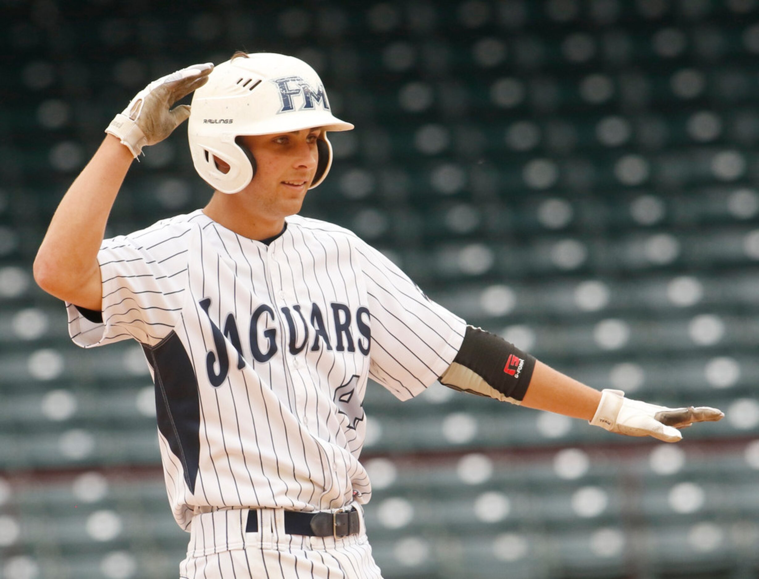 Flower Mound infielder Will Miller (4) gestures toward the dugout after advancing to 2nd...