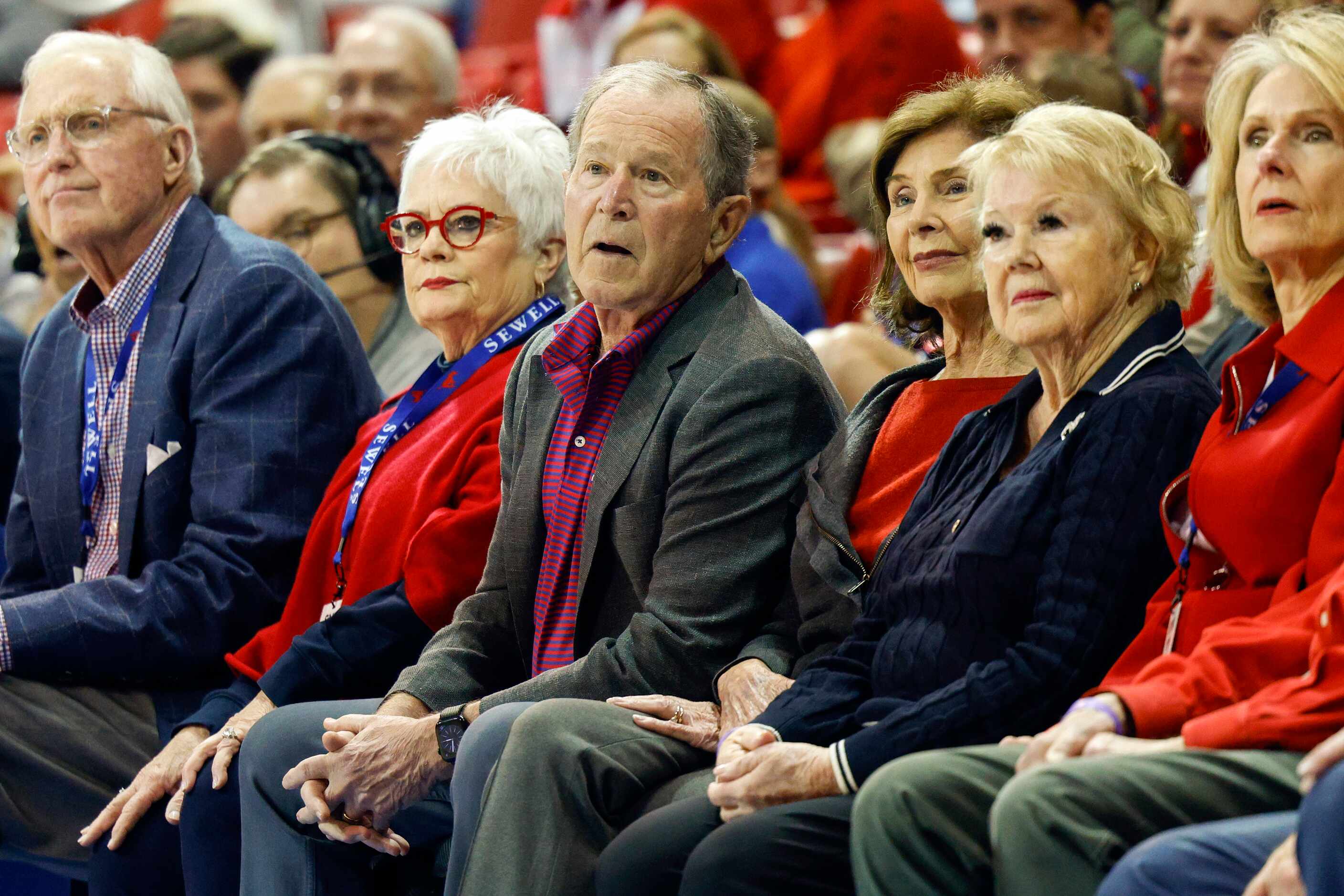Former President George W. Bush and Laura Bush watch the first half of an NCAA basketball...
