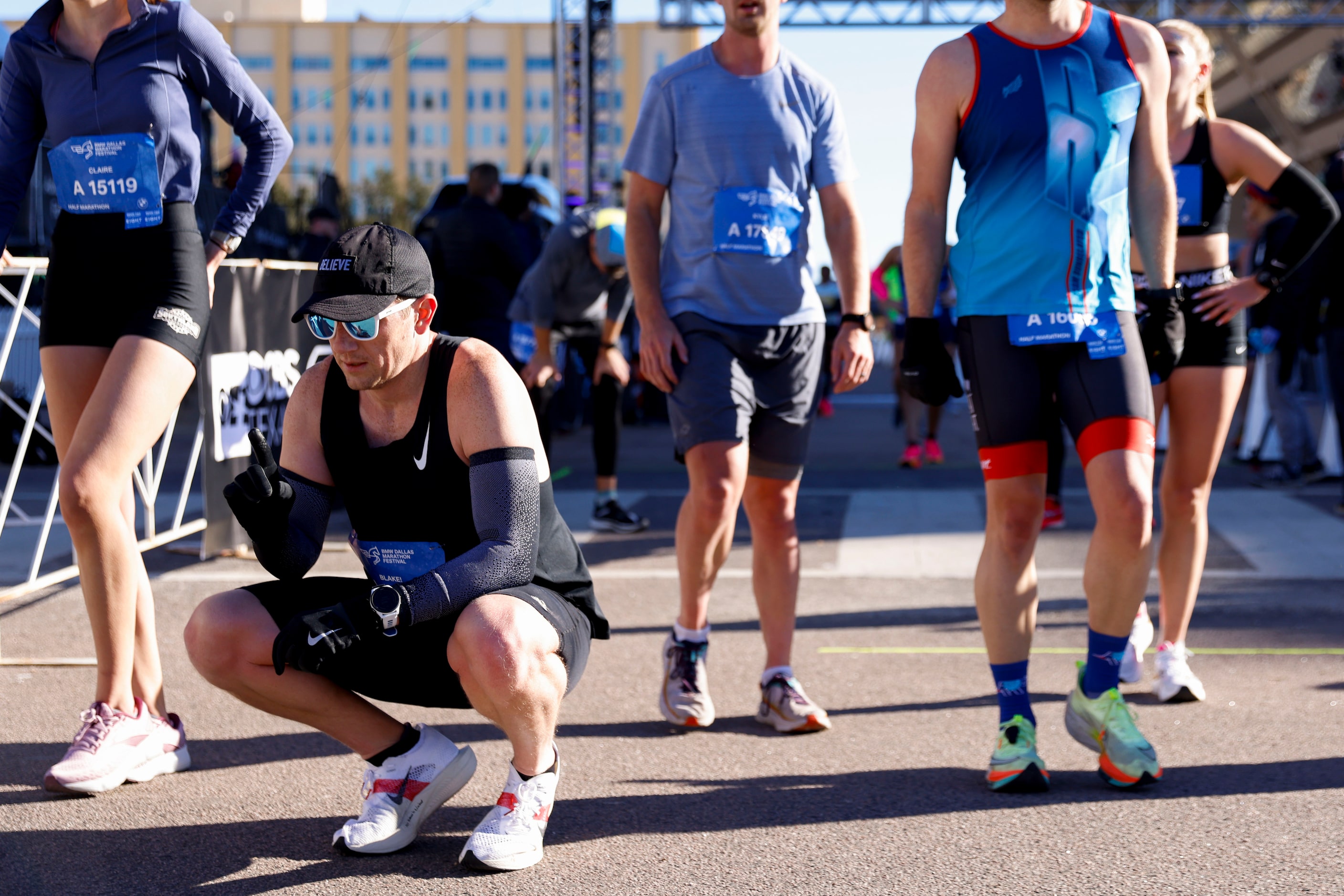 Half marathon runners catch their breath as they reach the finish line during 2023 BMW...