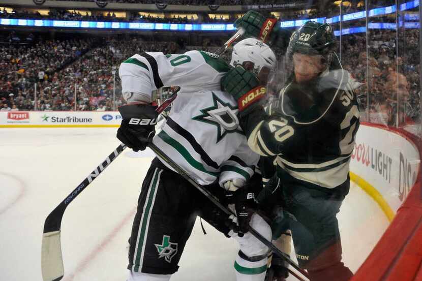 ST PAUL, MN - APRIL 24: Ryan Suter #20 of the Minnesota Wild pushes Cody Eakin #20 of the...