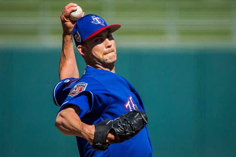Texas Rangers pitcher Mike Minor pitches during the fourth inning of a spring training...
