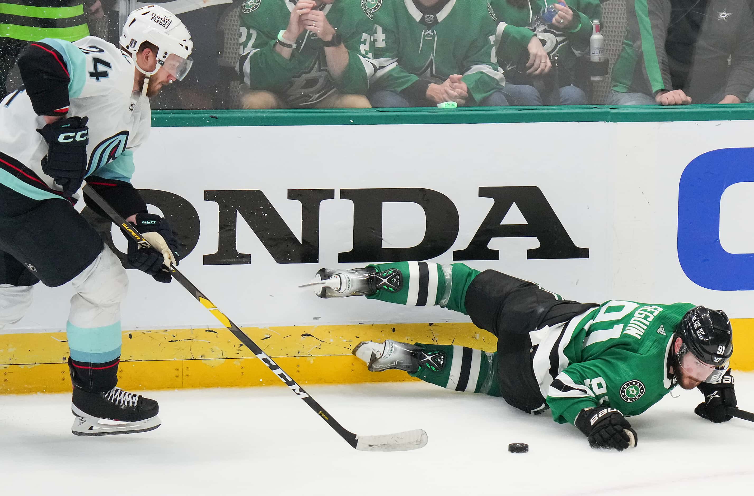 Dallas Stars center Tyler Seguin (91) reachs for the puck after hitting the ice against...