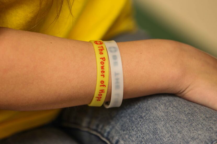 One of the 75 Hope Squad members at Prosper High School regularly wears a yellow band that...