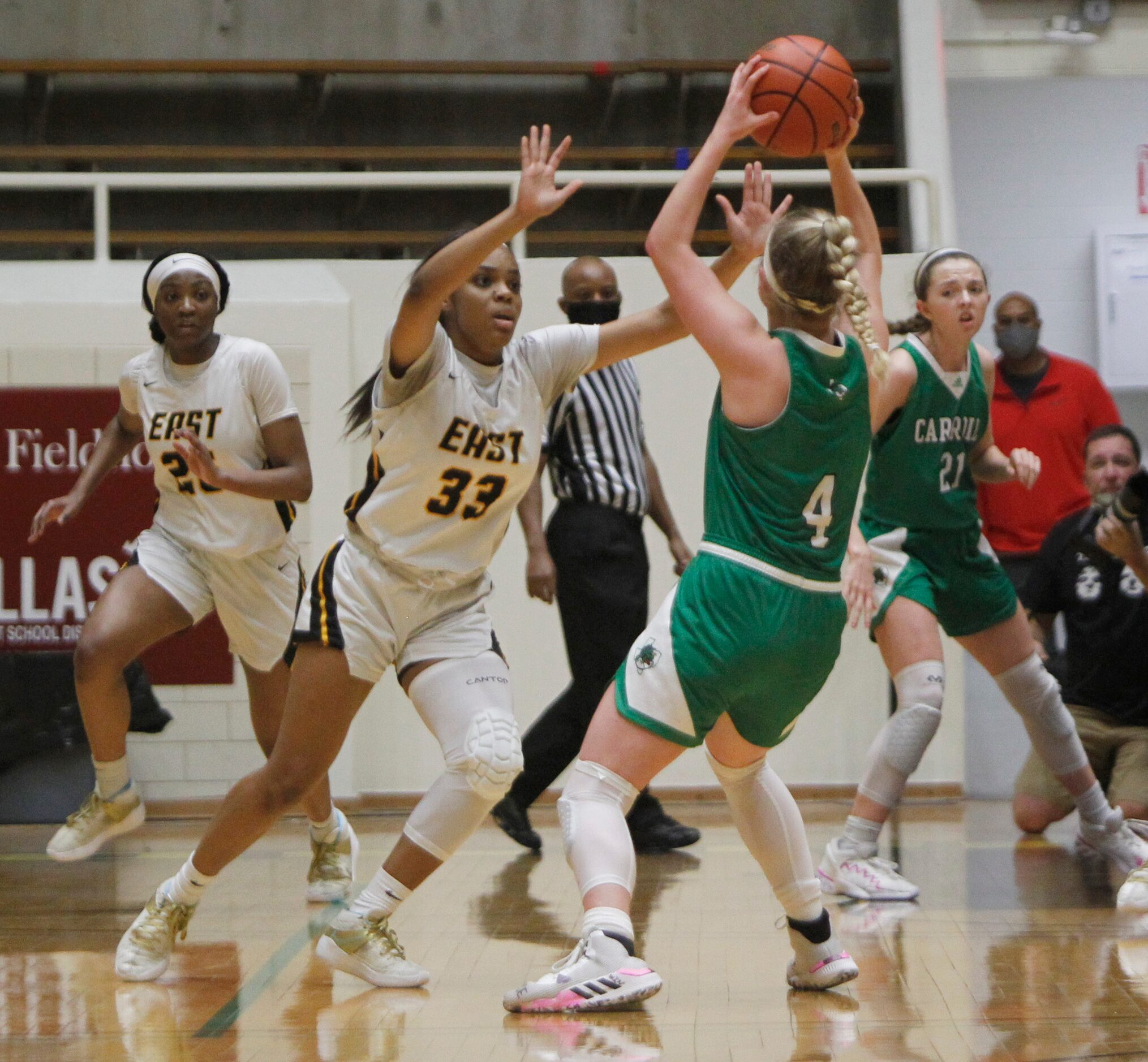 Southlake Carroll guard Brittney Flexer (4) looks to pass as she is defended by Plano East...