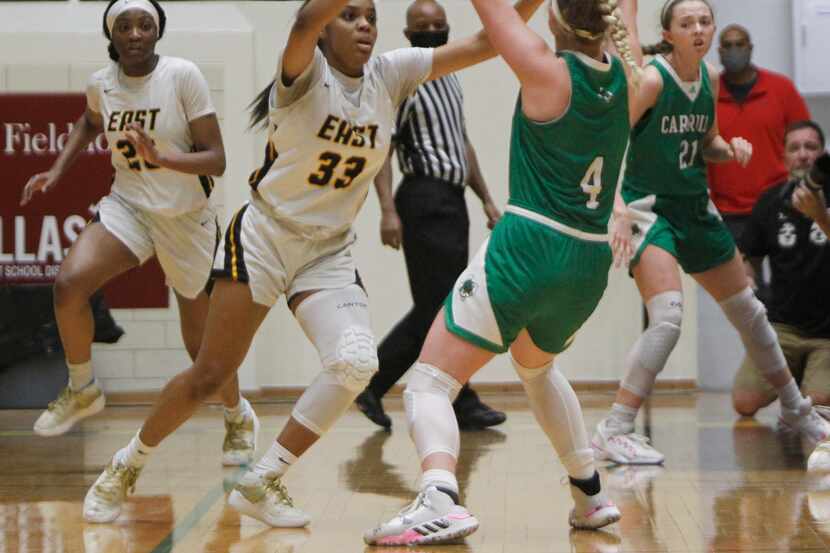 Southlake Carroll guard Brittney Flexer (4) looks to pass as she is defended by Plano East...