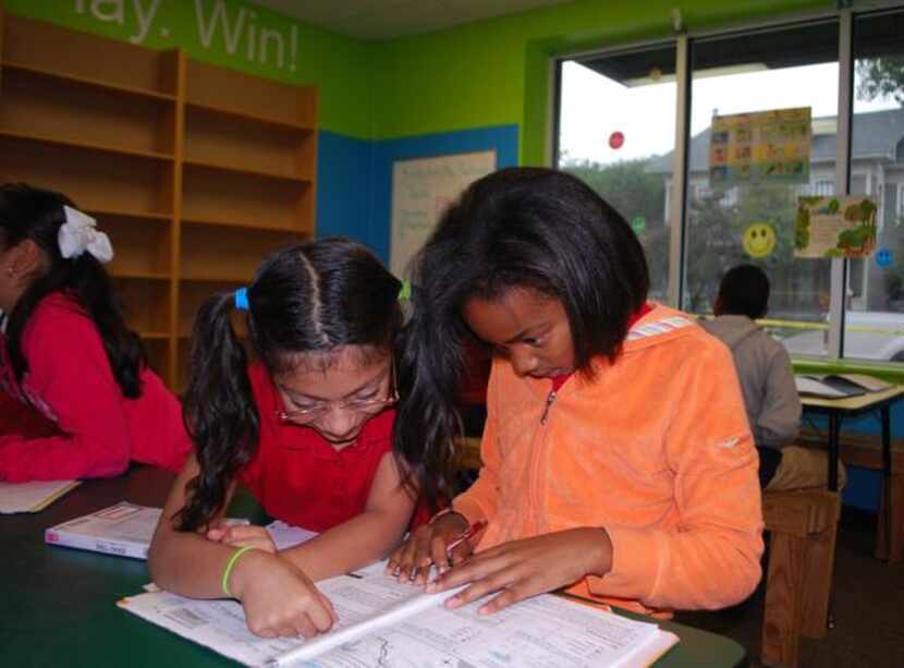 
Aniya Hurse (right) gets a little help from friend Breana Reyes during homework hour at the...