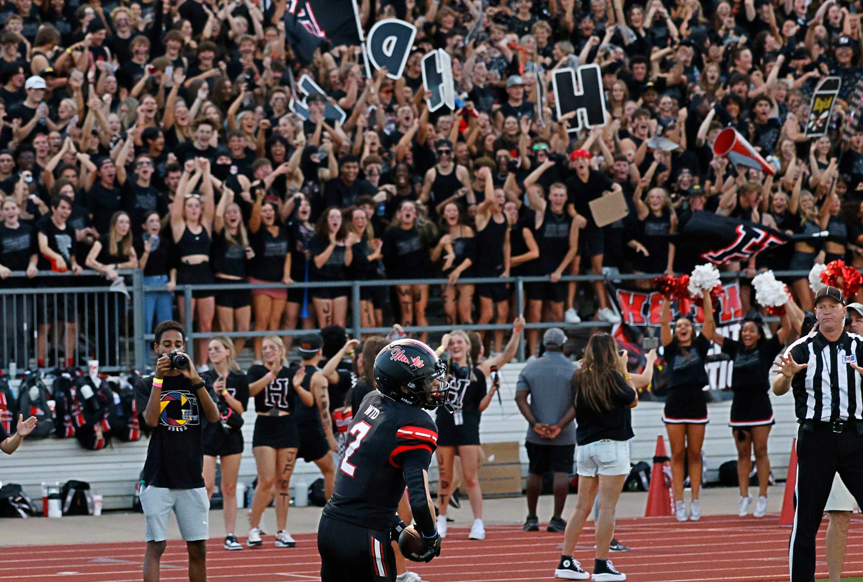 Rockwall-Heath fans cheer after Rockwall-Heath's Jack Traa (2) scored a touchdown during the...