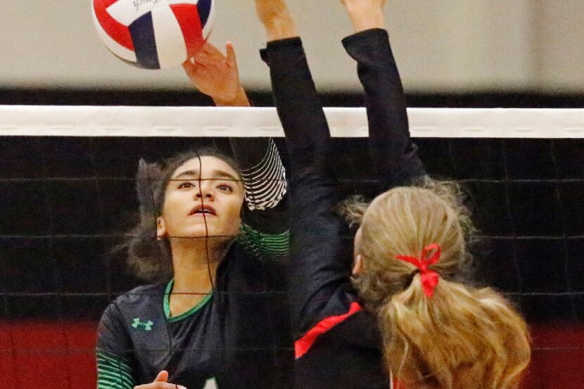 Southlake Carroll's Natalie Glenn (21) gets the ball over the net during a match against...