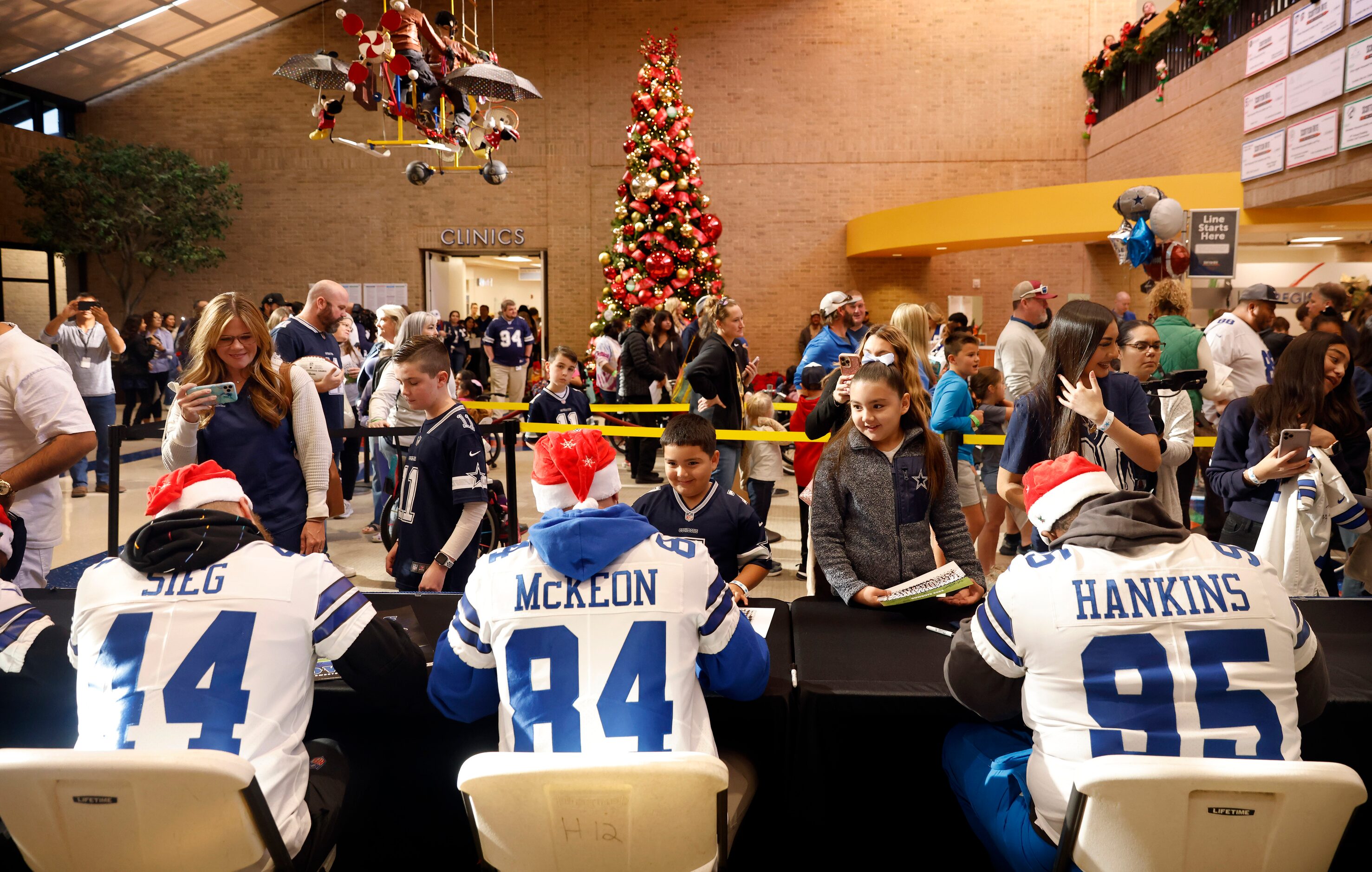 Dallas Cowboys players Trent Sieg (44), Sean McKeon (84) and Johnathan Hankins (95) sign...