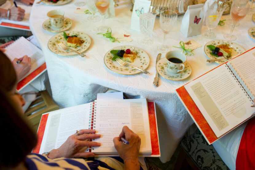 Ellen Welch takes notes in "Food for Thought" after the monthly potluck meeting of her...