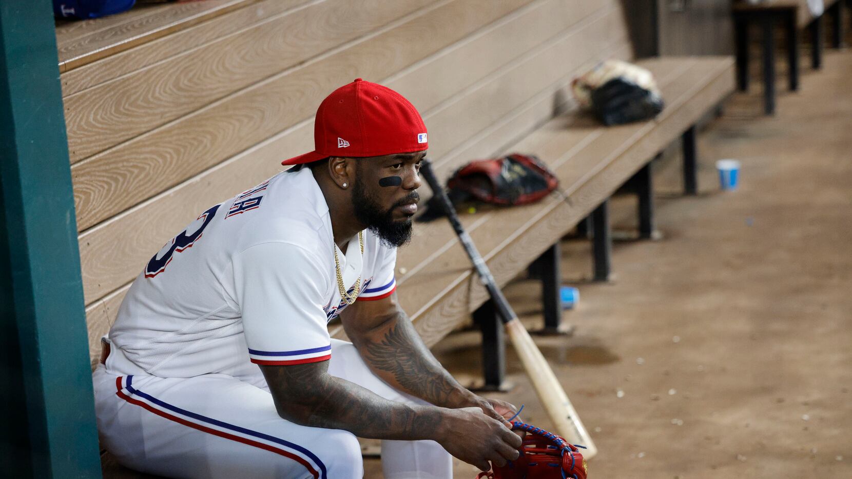 Texas Rangers right fielder Adolis Garcia (53) sit in the dugout before a baseball game...