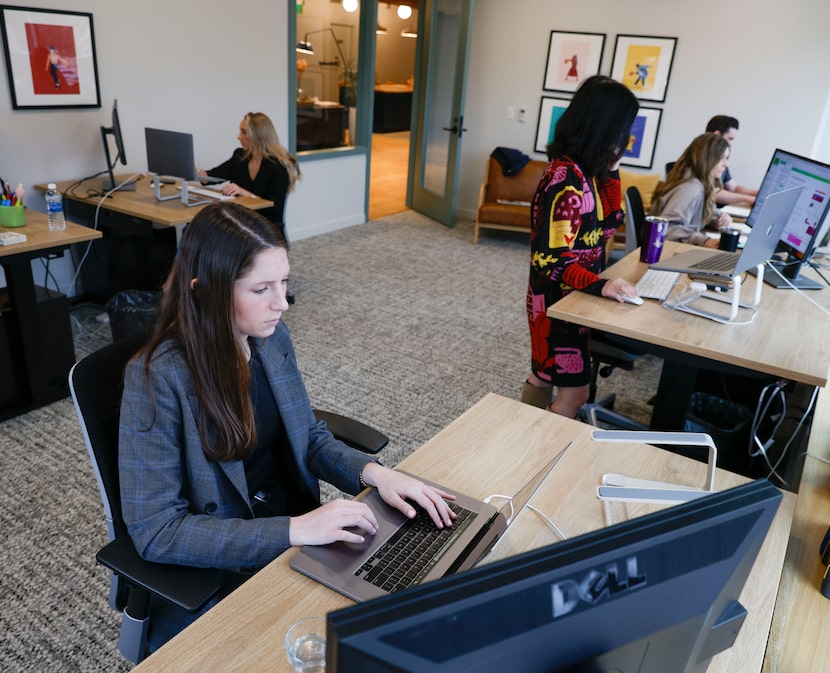 Genuine Article manager Mary-Ward Freydberg, front, is shown with some co-workers work at...