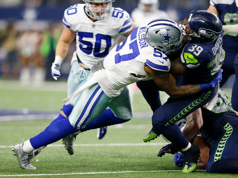 Dallas Cowboys outside linebacker Damien Wilson (57) tackles Seattle Seahawks running back...