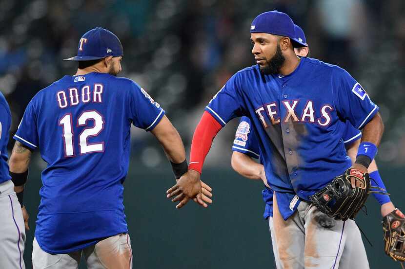 Texas Rangers' Elvis Andrus, right, celebrates with Rougned Odor (12) after a baseball game...