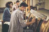 Students sketch pictures in an art class