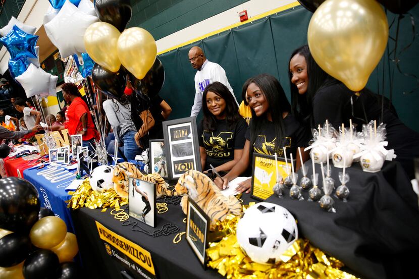 Soccer player Janna Singleton poses for a photograph with her family after signing with...
