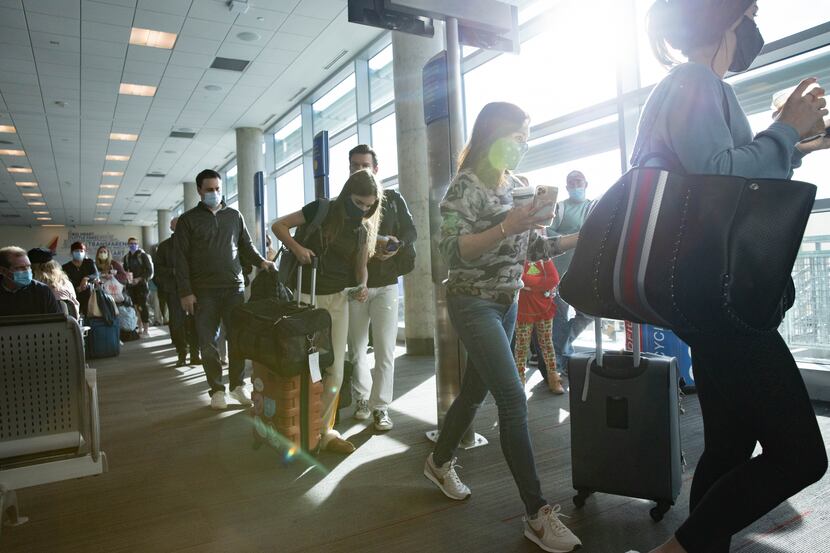 Holiday travelers board their Southwest flight at Dallas Love Field Airport in Dallas on...