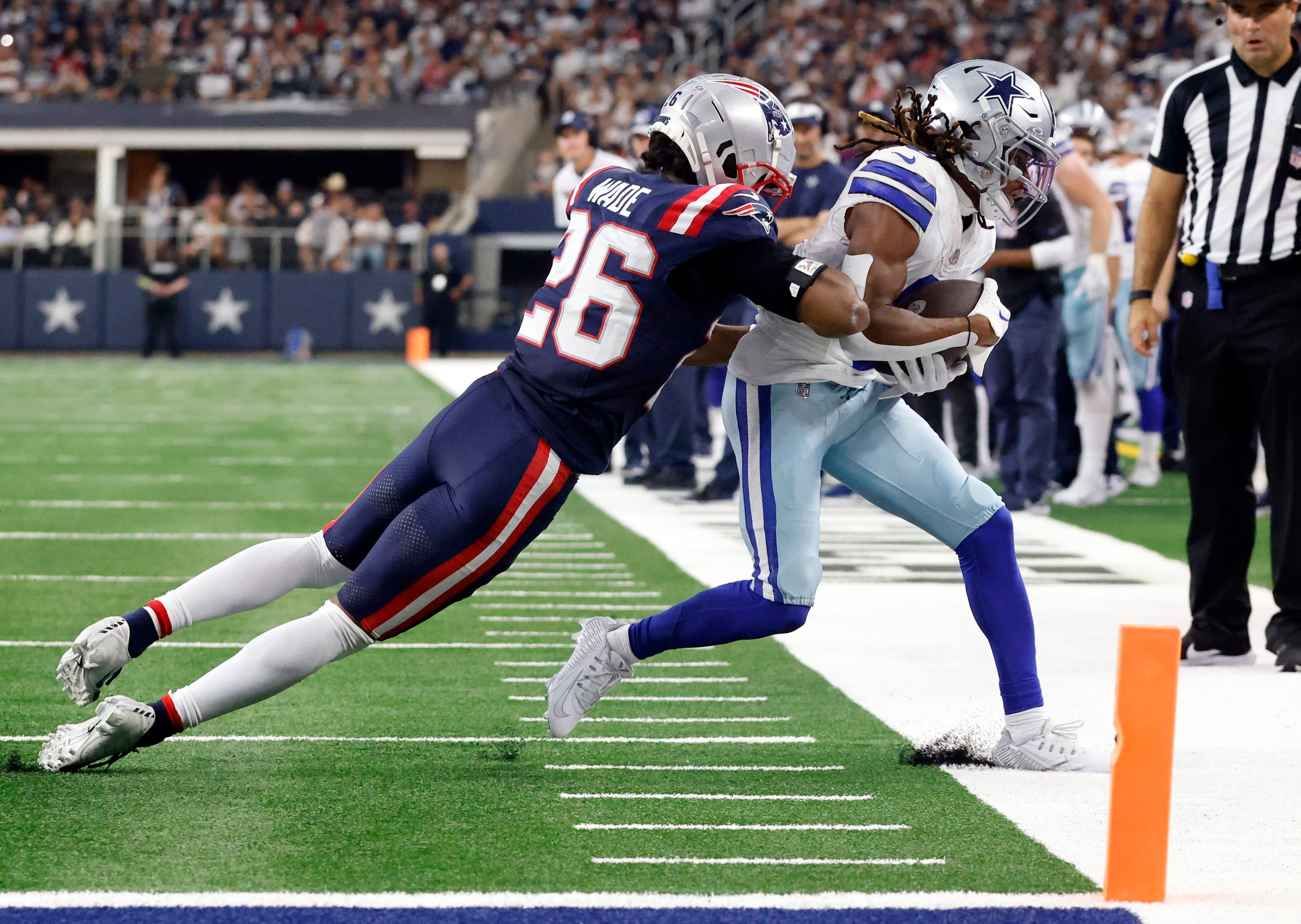 Dallas Cowboys wide receiver KaVontae Turpin (9) is pushed out of bounds by New England...