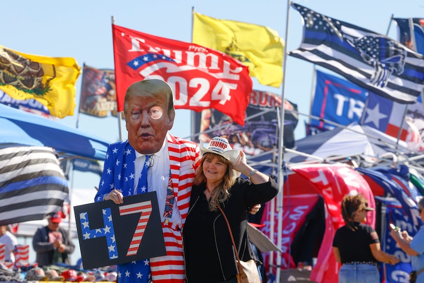 Rusty Lee, dressed as former President Donald Trump, poses for photos with people ahead of...