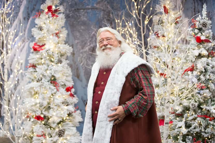 Santa Claus poses for a portrait this month at his Winter Woods setting at  Fairview Town...
