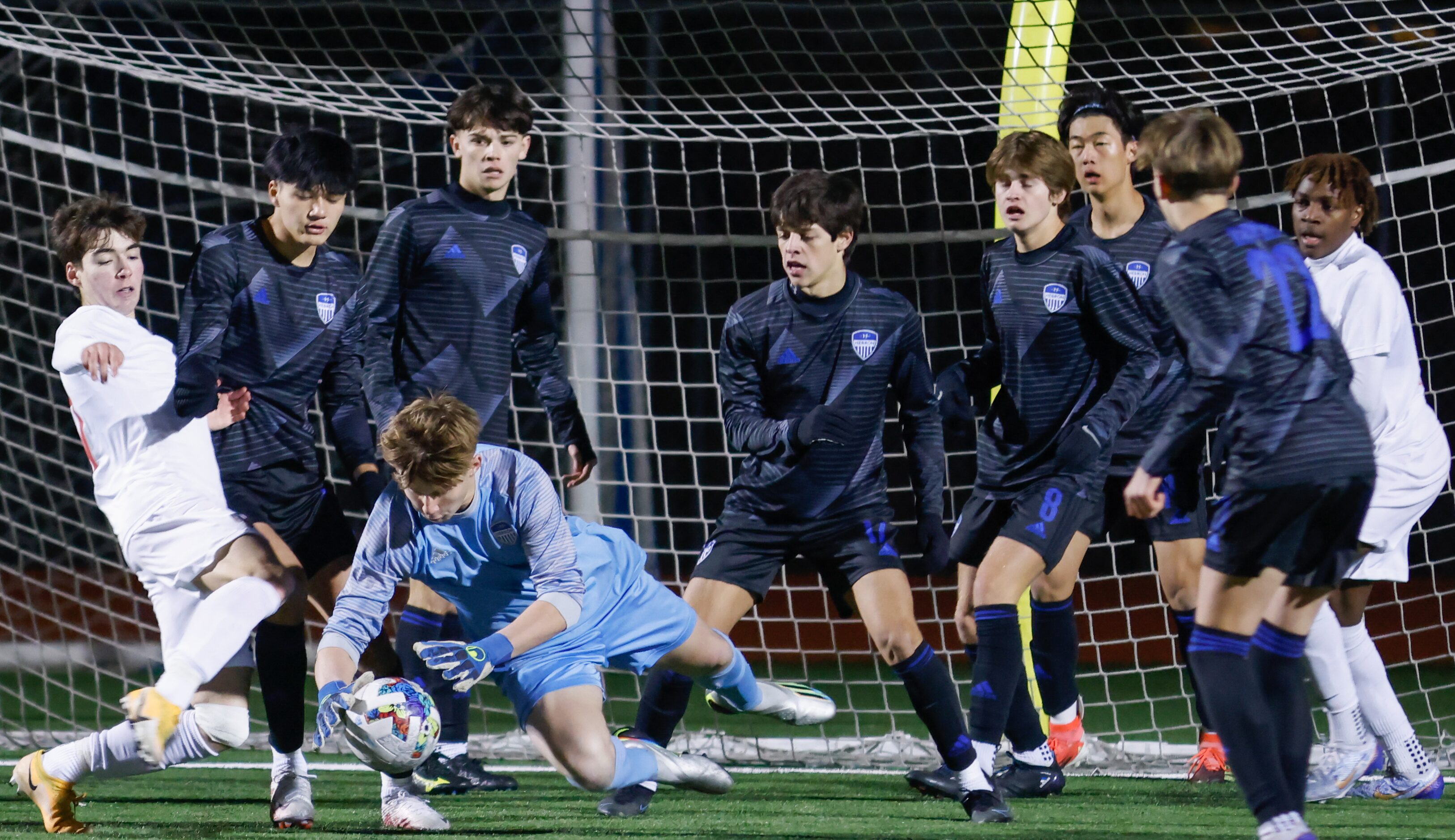 Hebron goalkeeper Evan Mayhaw (1) jumps on the ball as Flower Mound Marcus’ Artian Rifati...