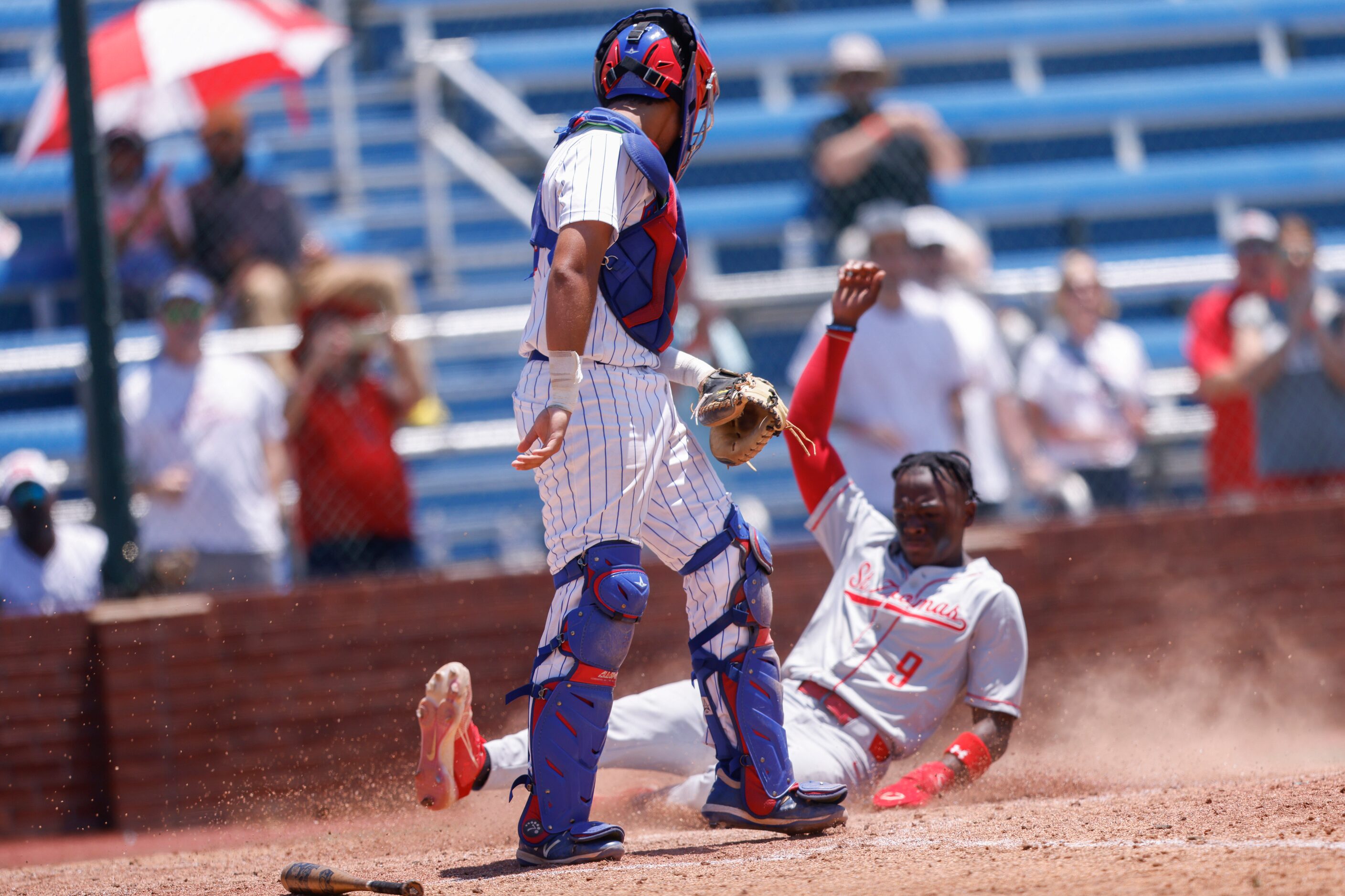 Houston St. Thomas’ Donte Lewis (9) slides into home against Trinity Christian catcher Ajay...