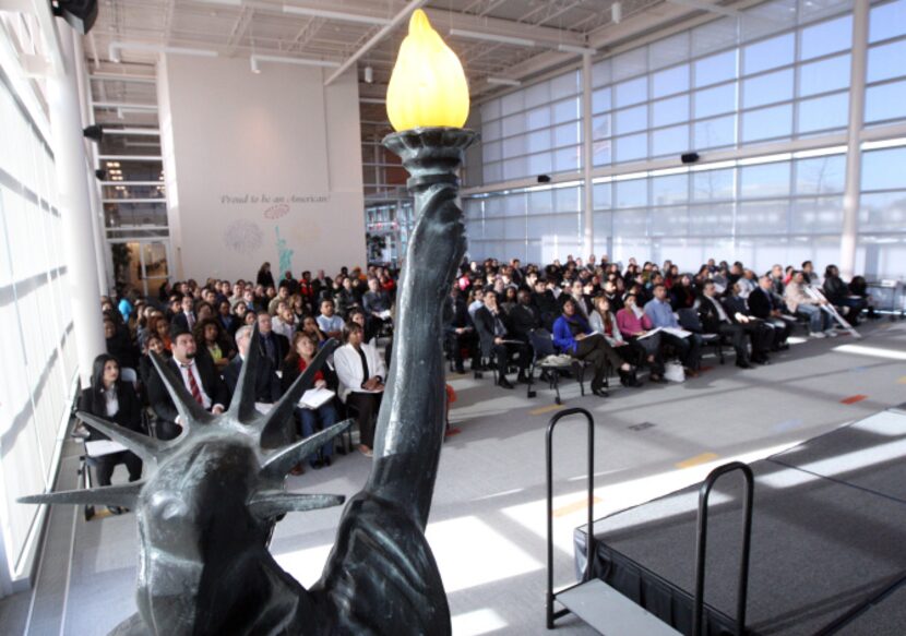 Applicants are sworn in as newly naturalized citizens at the U.S. Citizenship and...