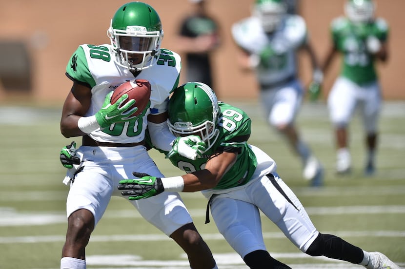 North Texas sophomore defensive back Andrew Jones (38) is tackled by senior wide receiver...