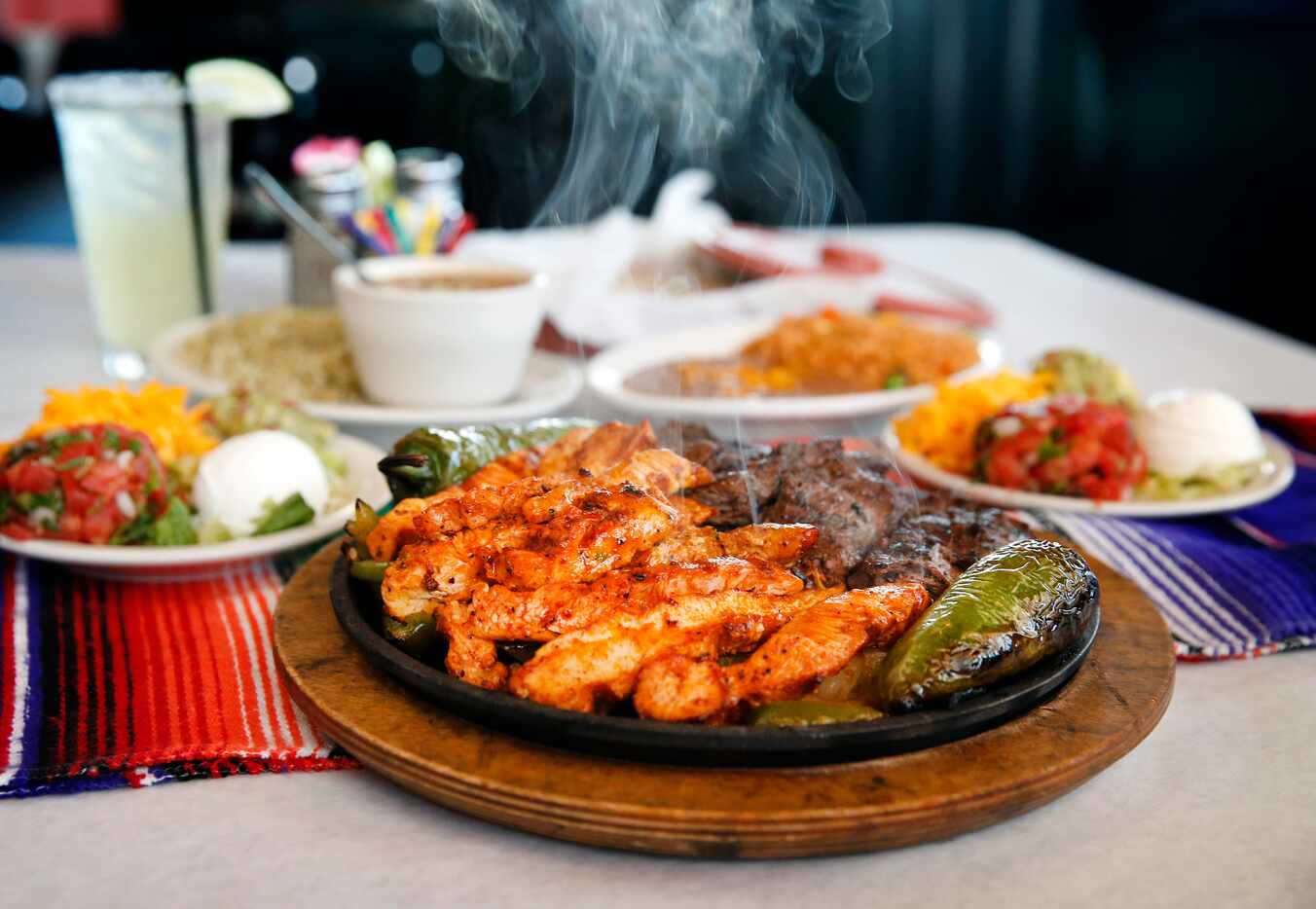 The two-person fajitas plate of chicken and beef with all the fixings is served at El...