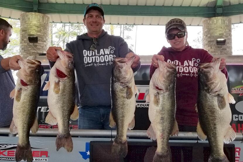 Clint Wade (center) and his girlfriend, Stacy Spriggs, display the massive 37.80-pound limit...