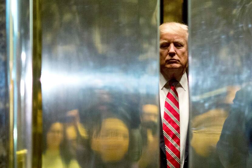 US President-elect Donald Trump boards the elevator after escorting Martin Luther King III...