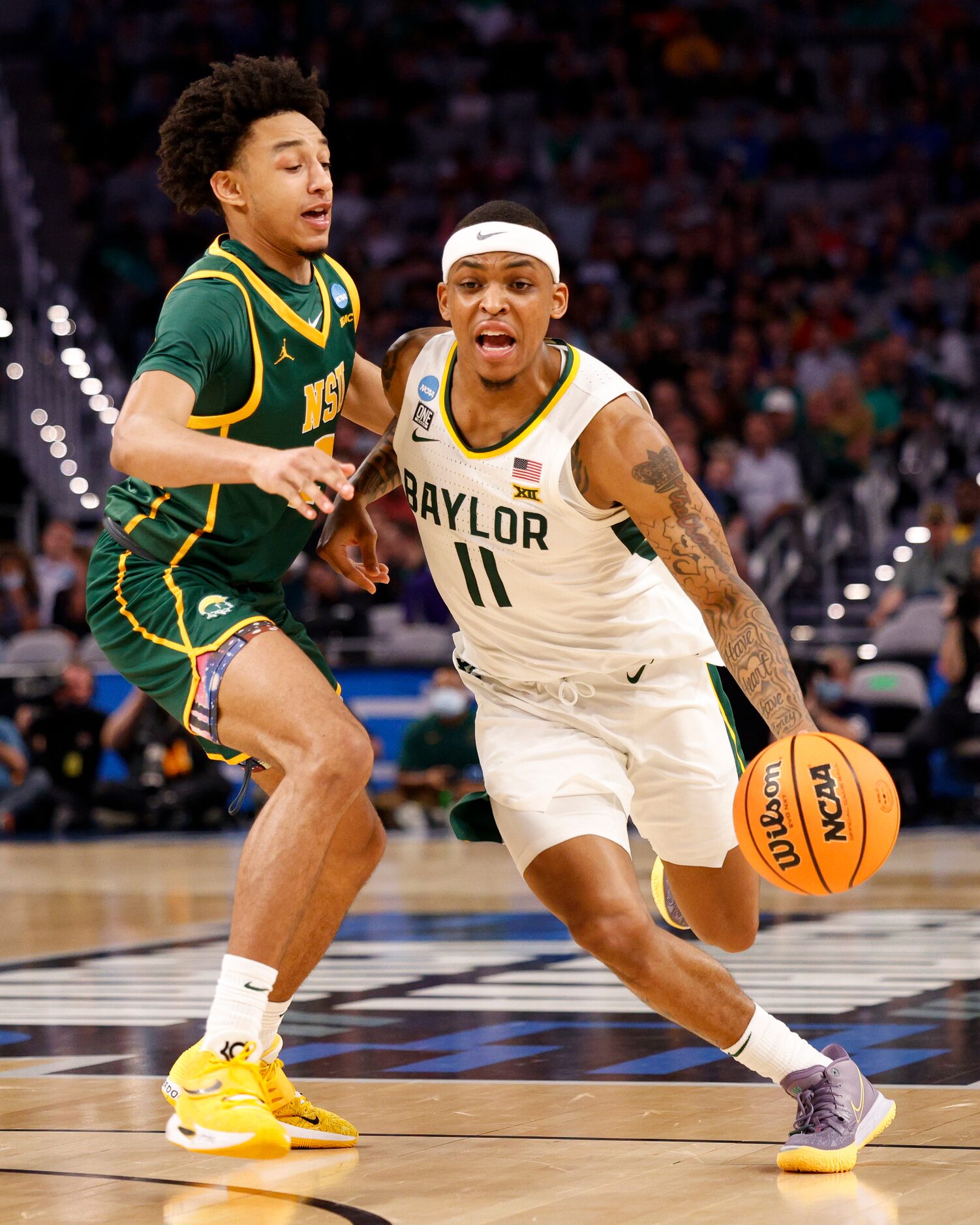 Baylor Bears guard James Akinjo (11) drives past Norfolk State Spartans guard Terrance Jones...